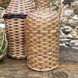 Glass bottles and rattan, woven wicker
