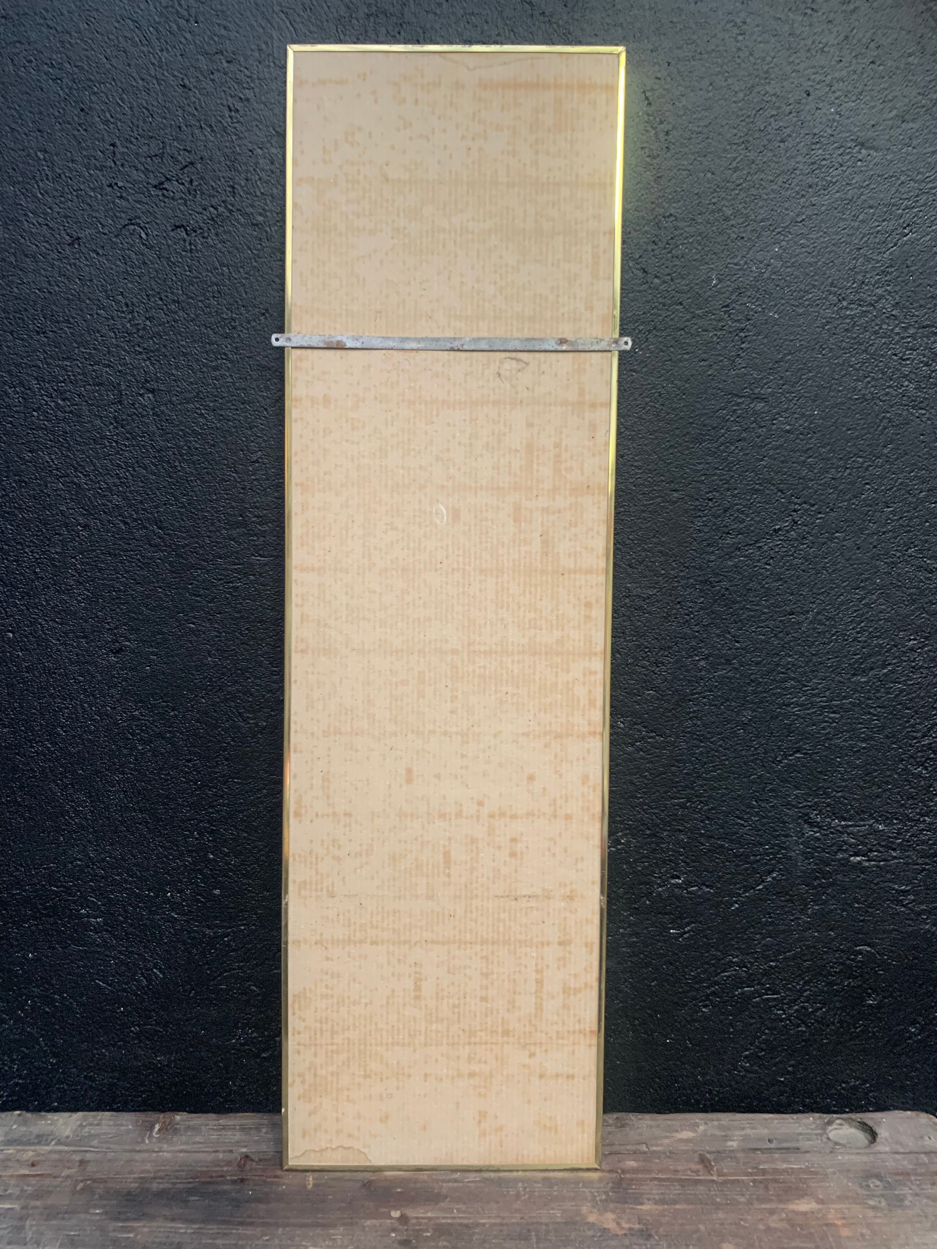 Mirror of two, narrow glass in gold metal 1950