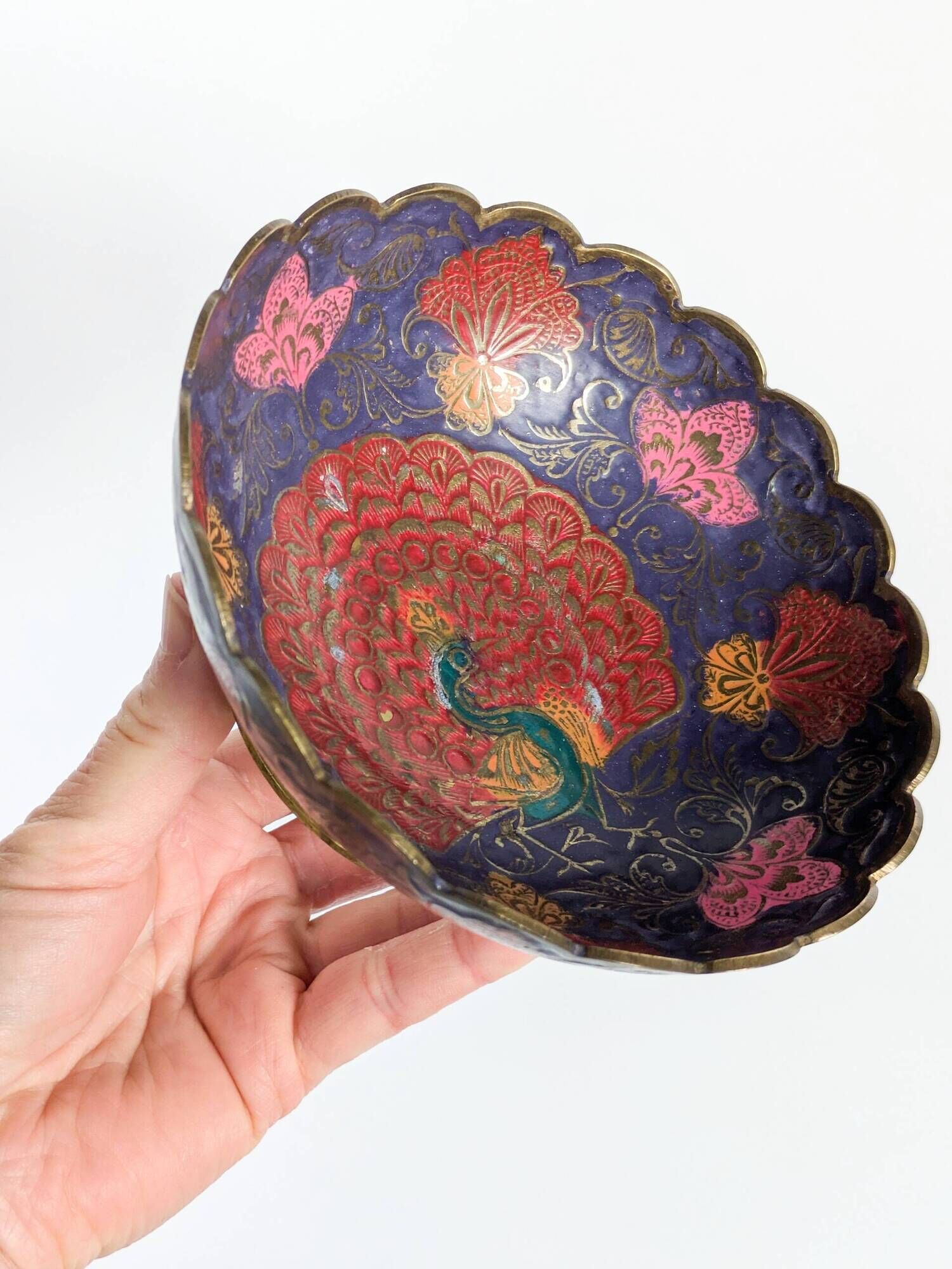 Vintage brass bowl with peacock motif, painted enamel, scalloped edge on a pedestal.