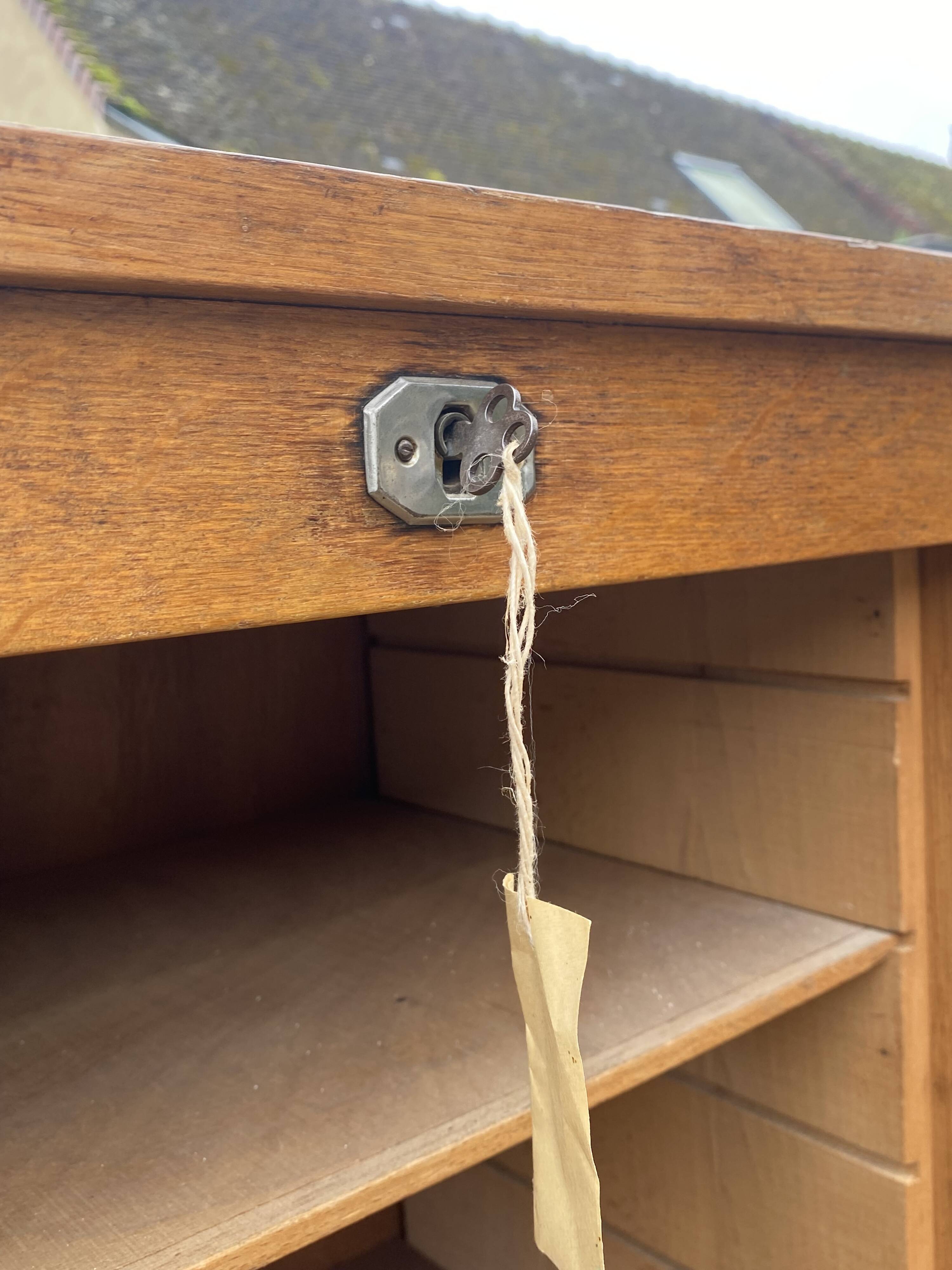 Double-column oak filing cabinet with curtains, 1950s.
