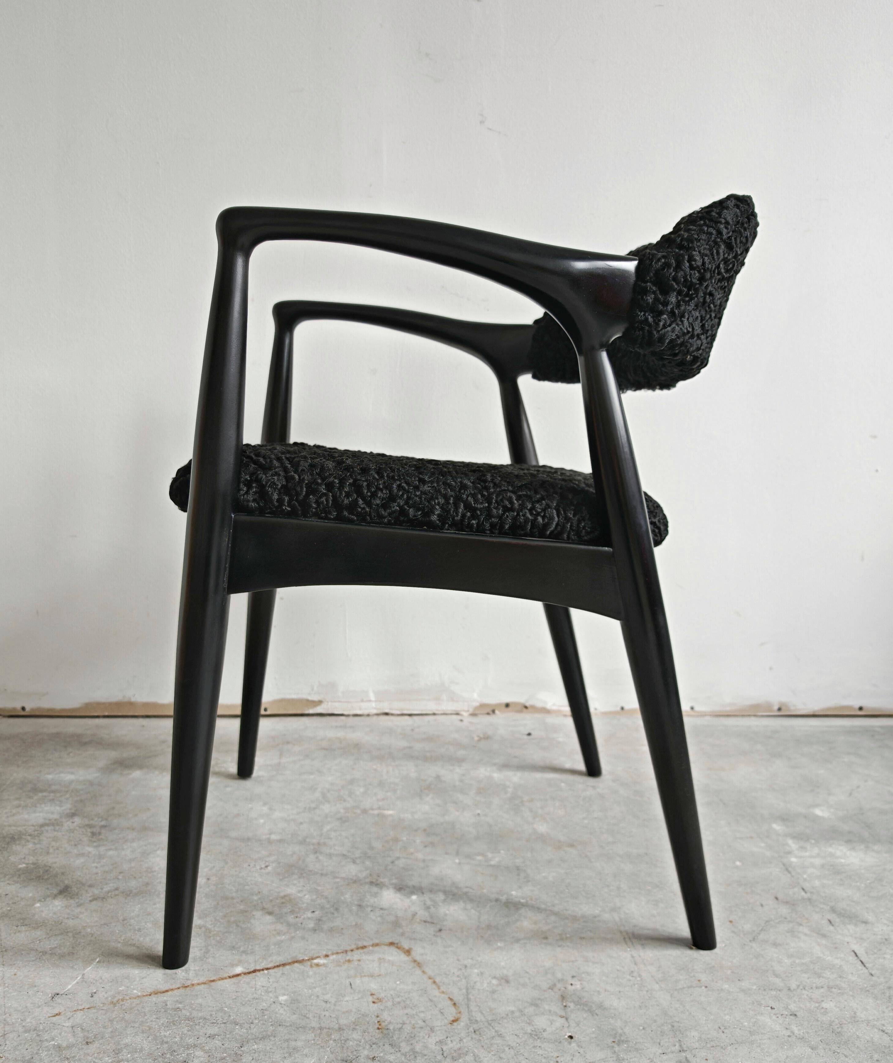 Pair of Mid Century Modern armchairs in astrakhan leather.