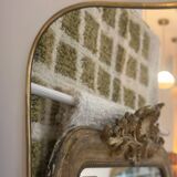 Long trapezoidal mirror in curved gilded brass, art deco modernist