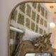 Long trapezoidal mirror in gilded brass, curved Art Deco modernist.