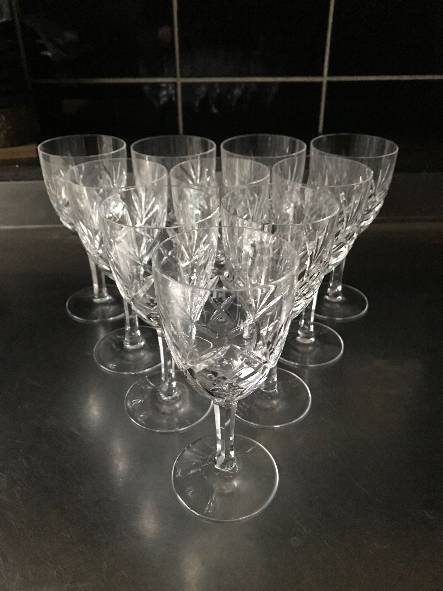 Crystal cut water stemmed glasses. Star and leaf patterns.