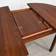 Extendable round rosewood dining table