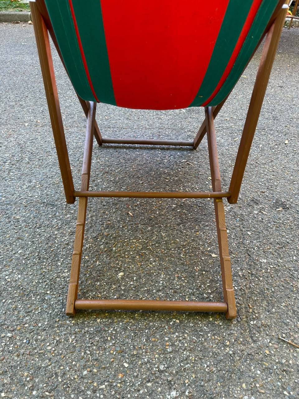 Vintage folding wooden deck chair with red and green striped canvas from the 1970s.