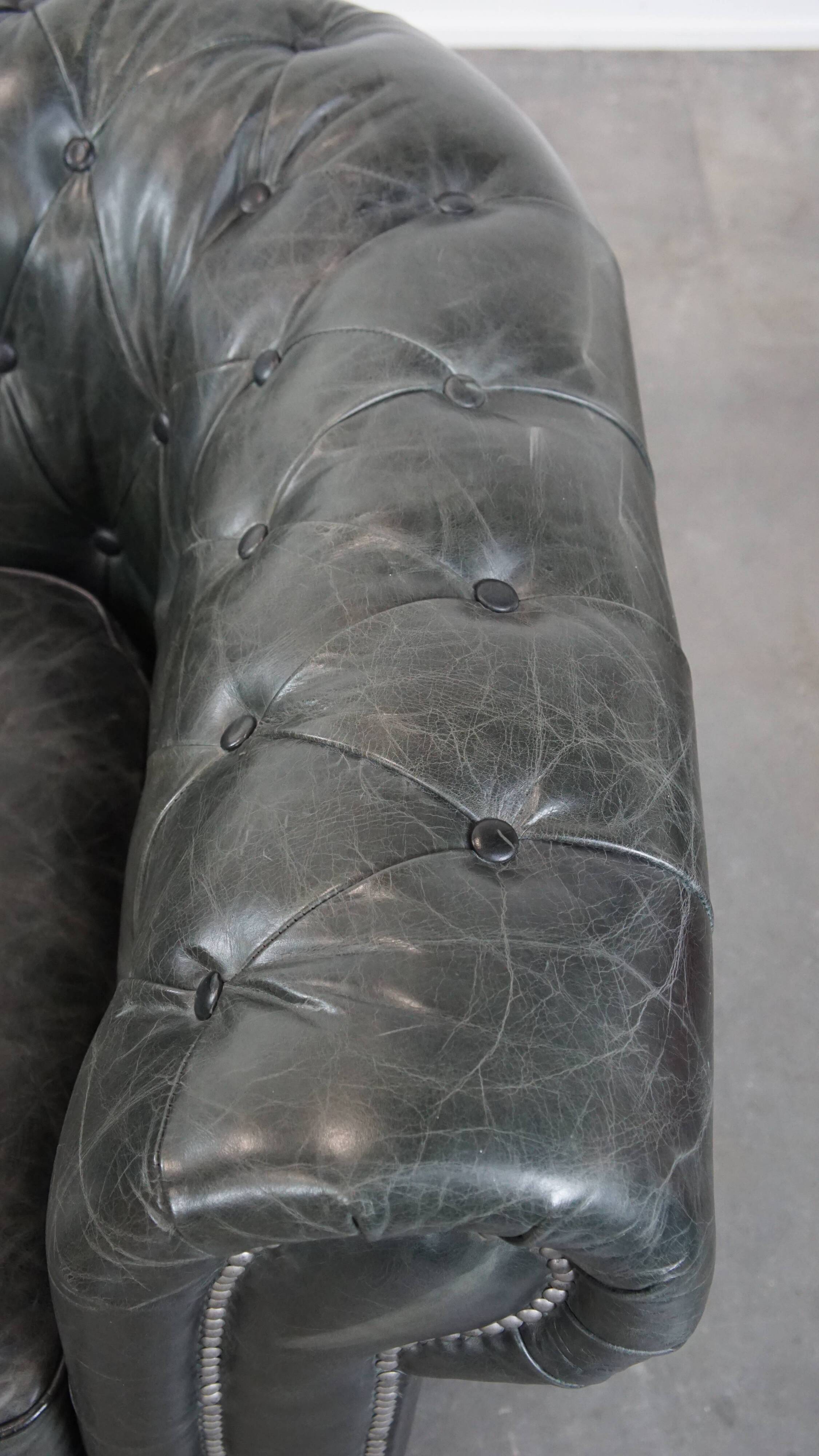 Black Chesterfield armchair made of grained cowhide leather