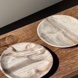 Tray, circular dish or plate made of white striped grey petrified wood.