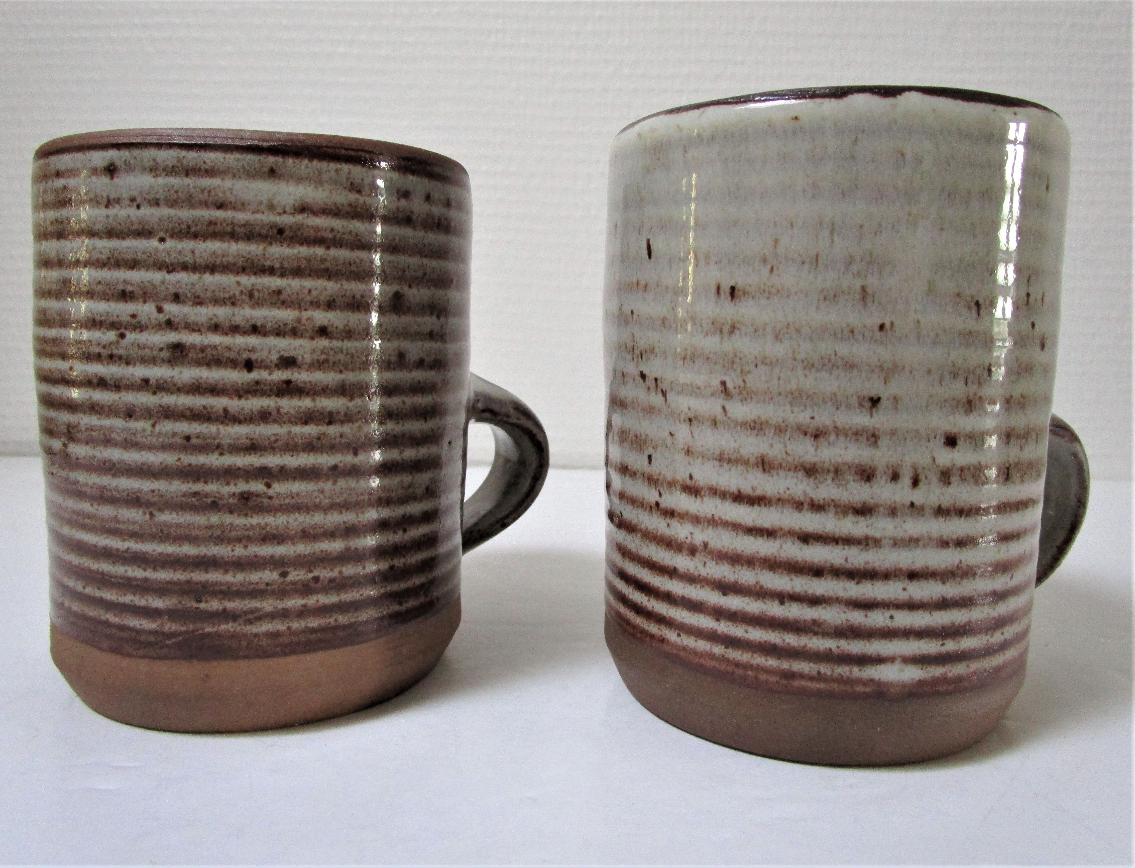 Two enamelled sandstone mugs Roger Jacques handwritten signature