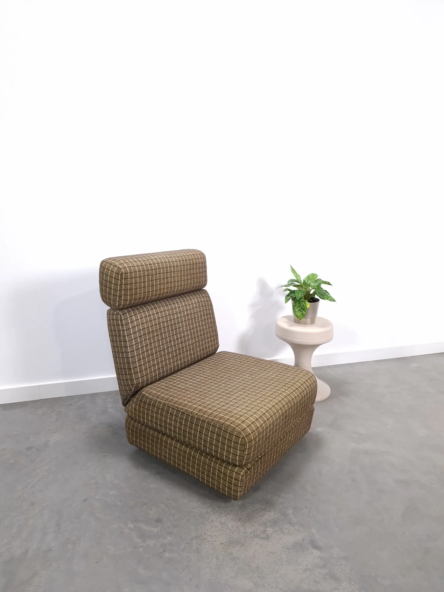 Vintage pull-out sofa bed, brown checked lounge chair with chrome.