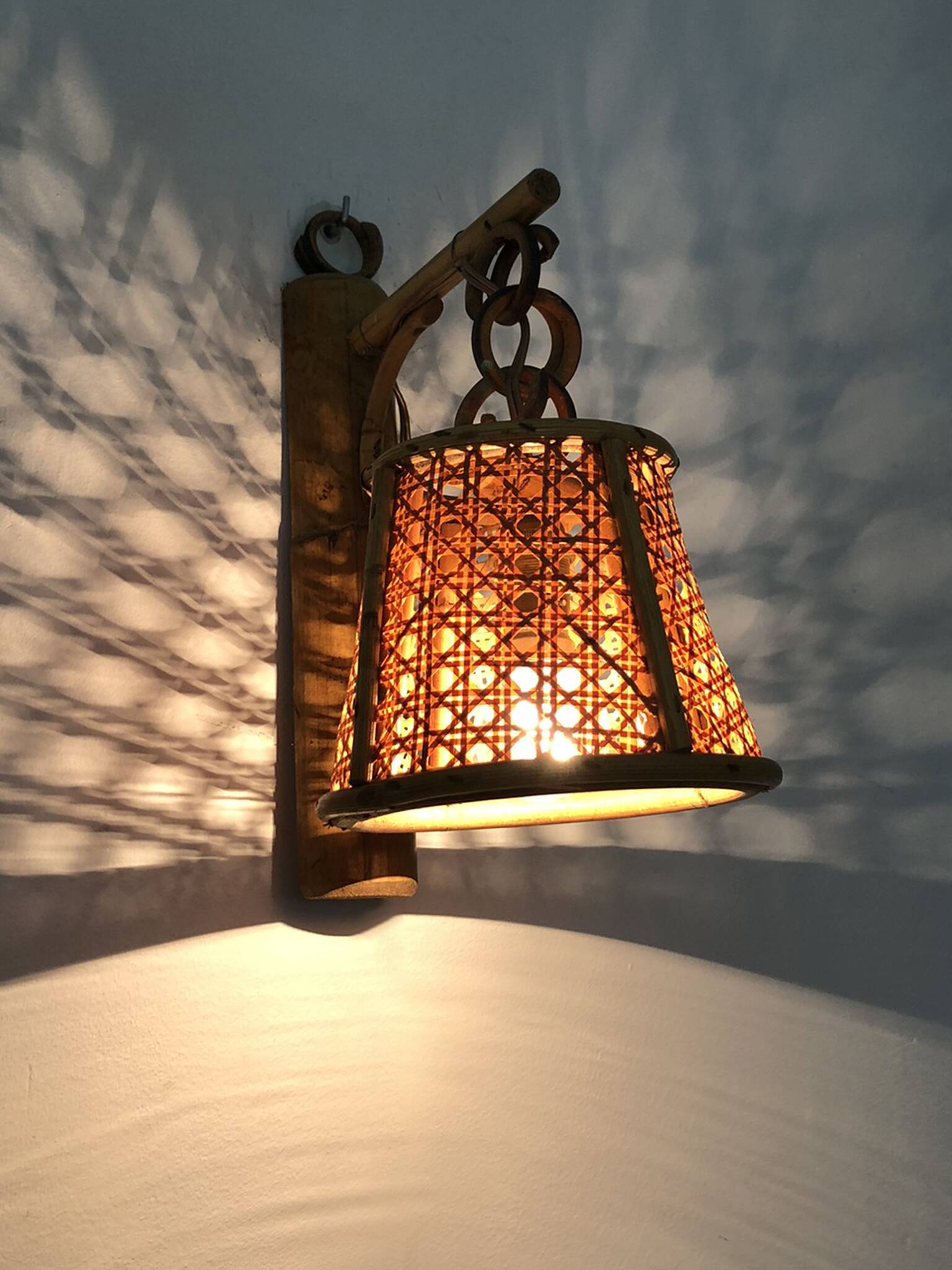 Pair of rattan and cane lantern wall lights. 1950s-60s