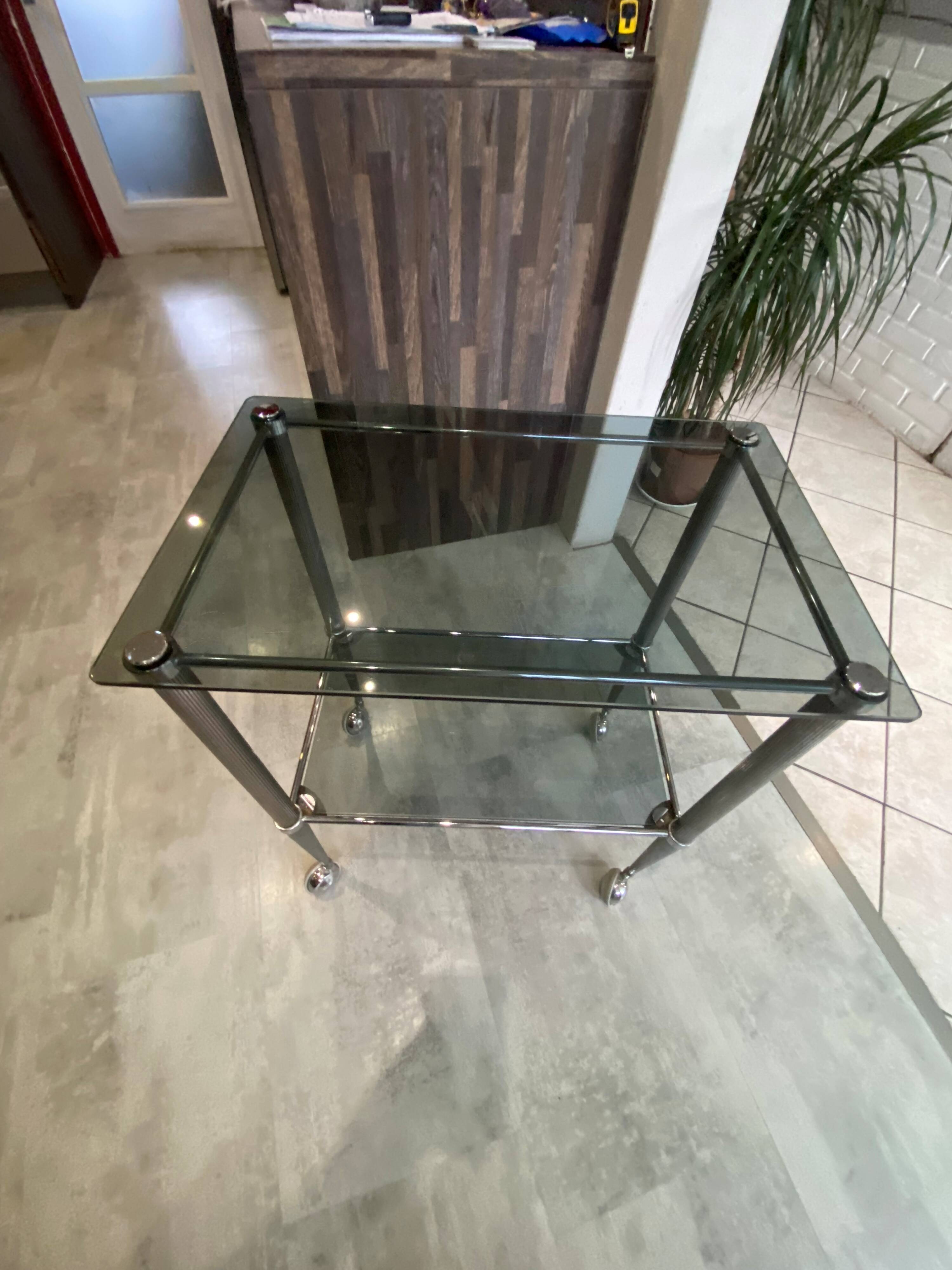 Serving dessert trolley with 2 smoked glass shelves and metal structure.