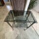 Serving dessert trolley with 2 smoked glass shelves and metal structure.