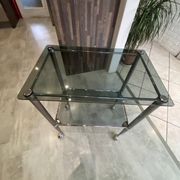 Serving dessert trolley with 2 smoked glass shelves and metal structure.