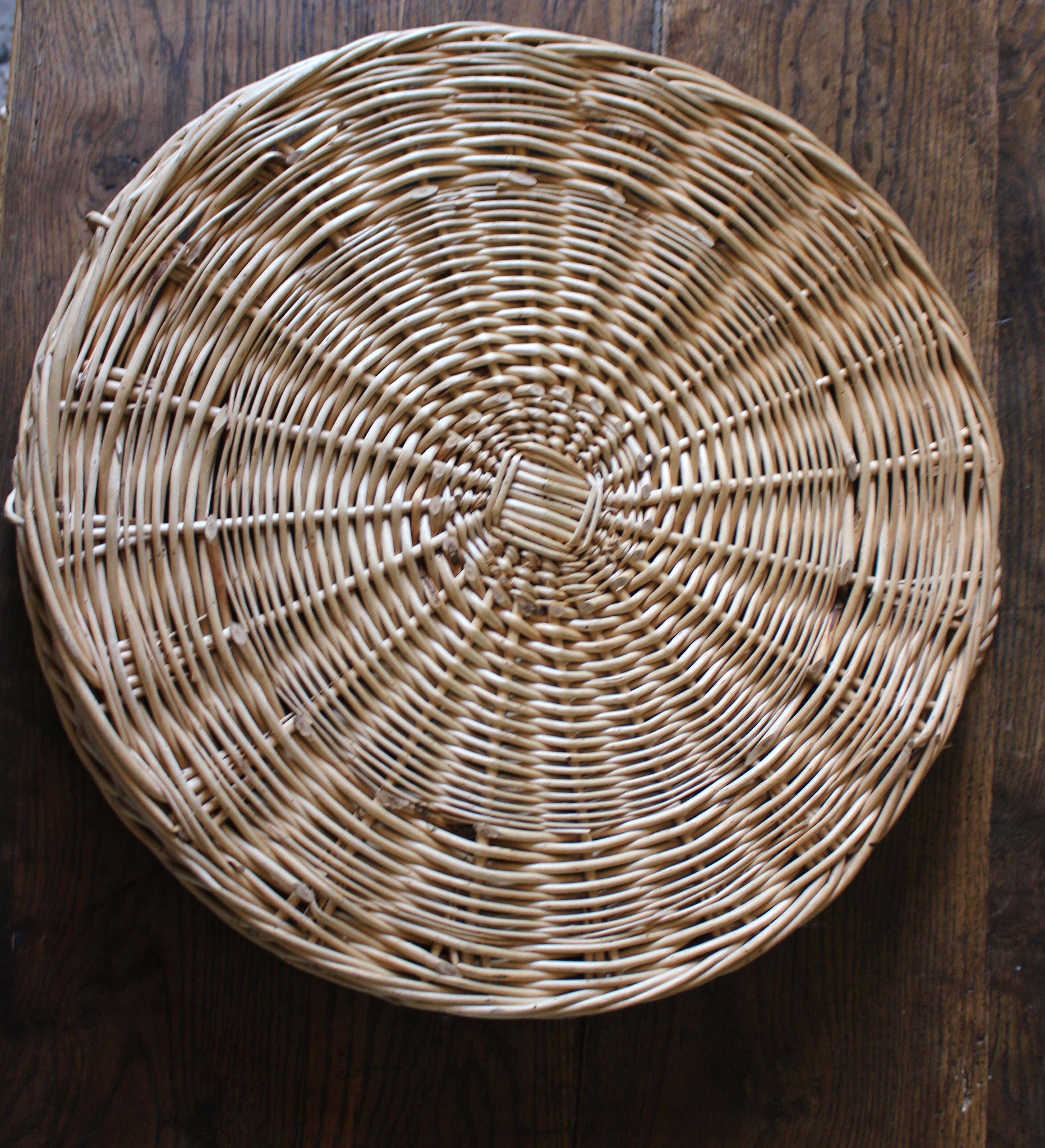 Large round wicker tray with two handles, vintage weaving.