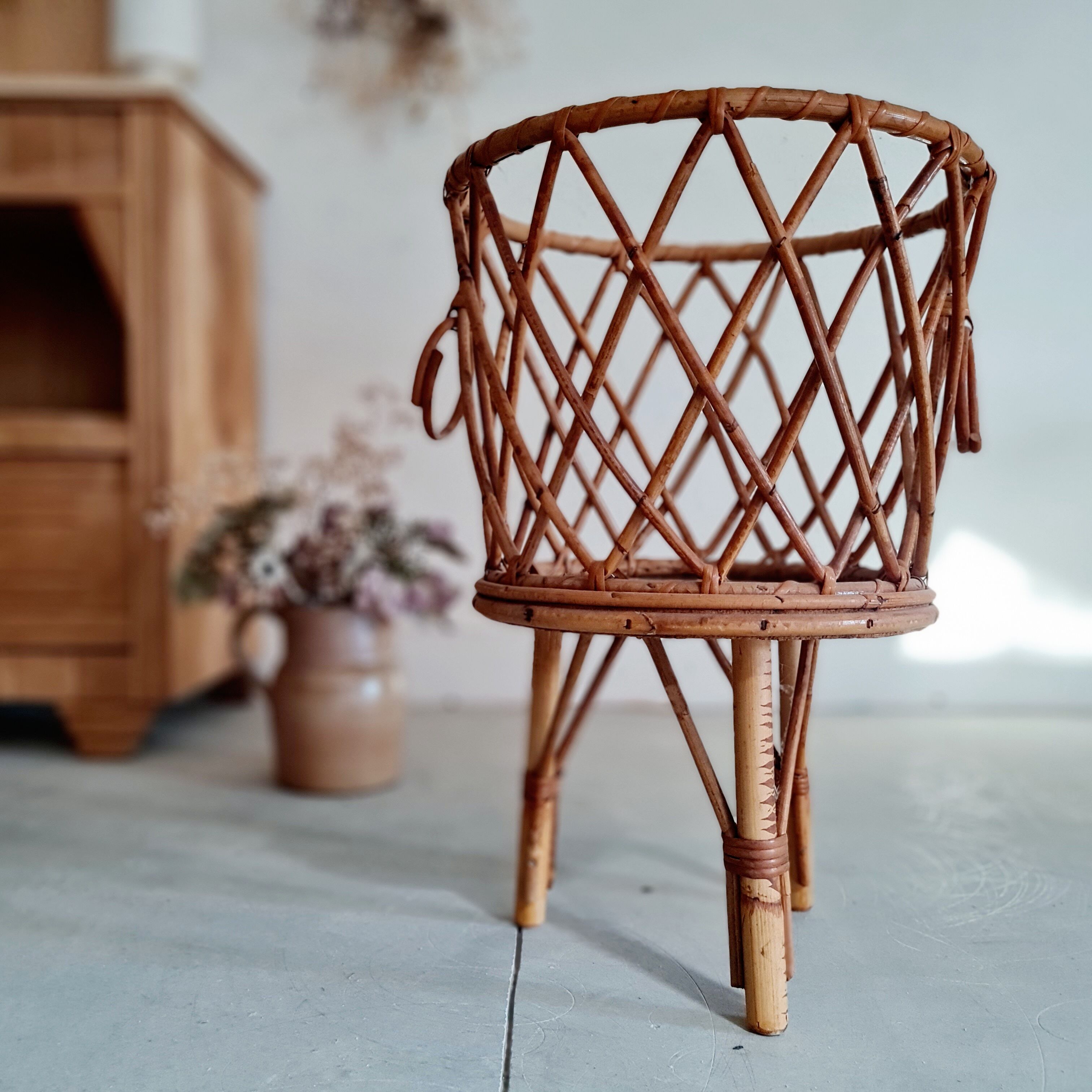 Old tripod rattan plant holder