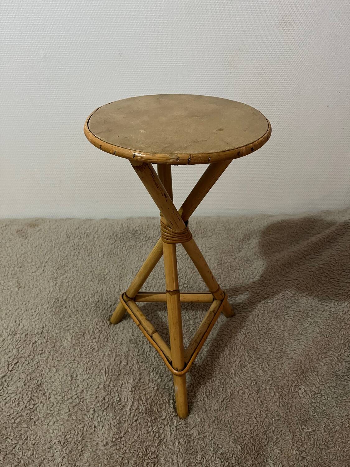 Plant holder or side table at the end of a bamboo sofa