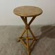 Plant holder or side table at the end of a bamboo sofa