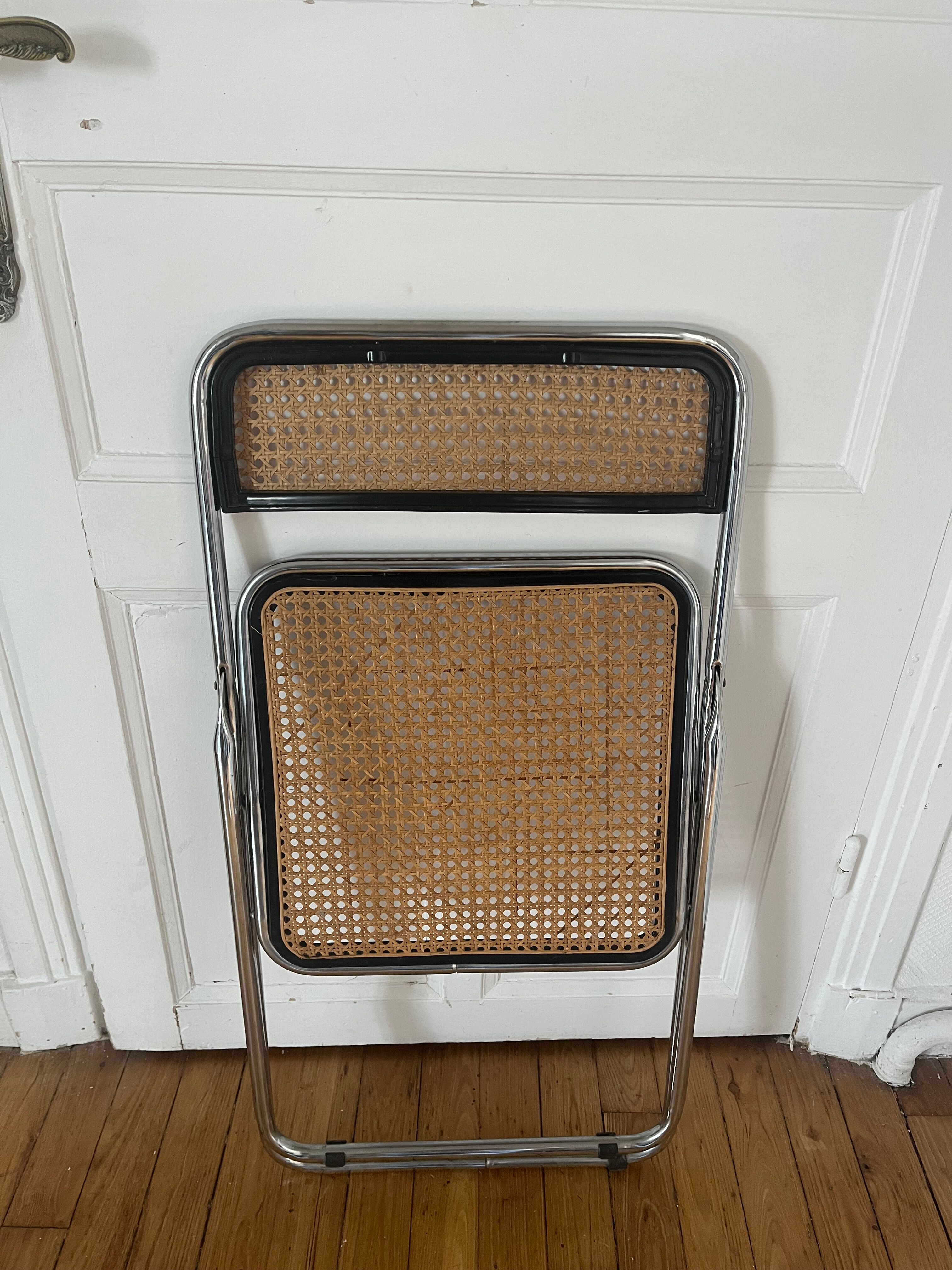 Vintage folding chair in metal and cane.