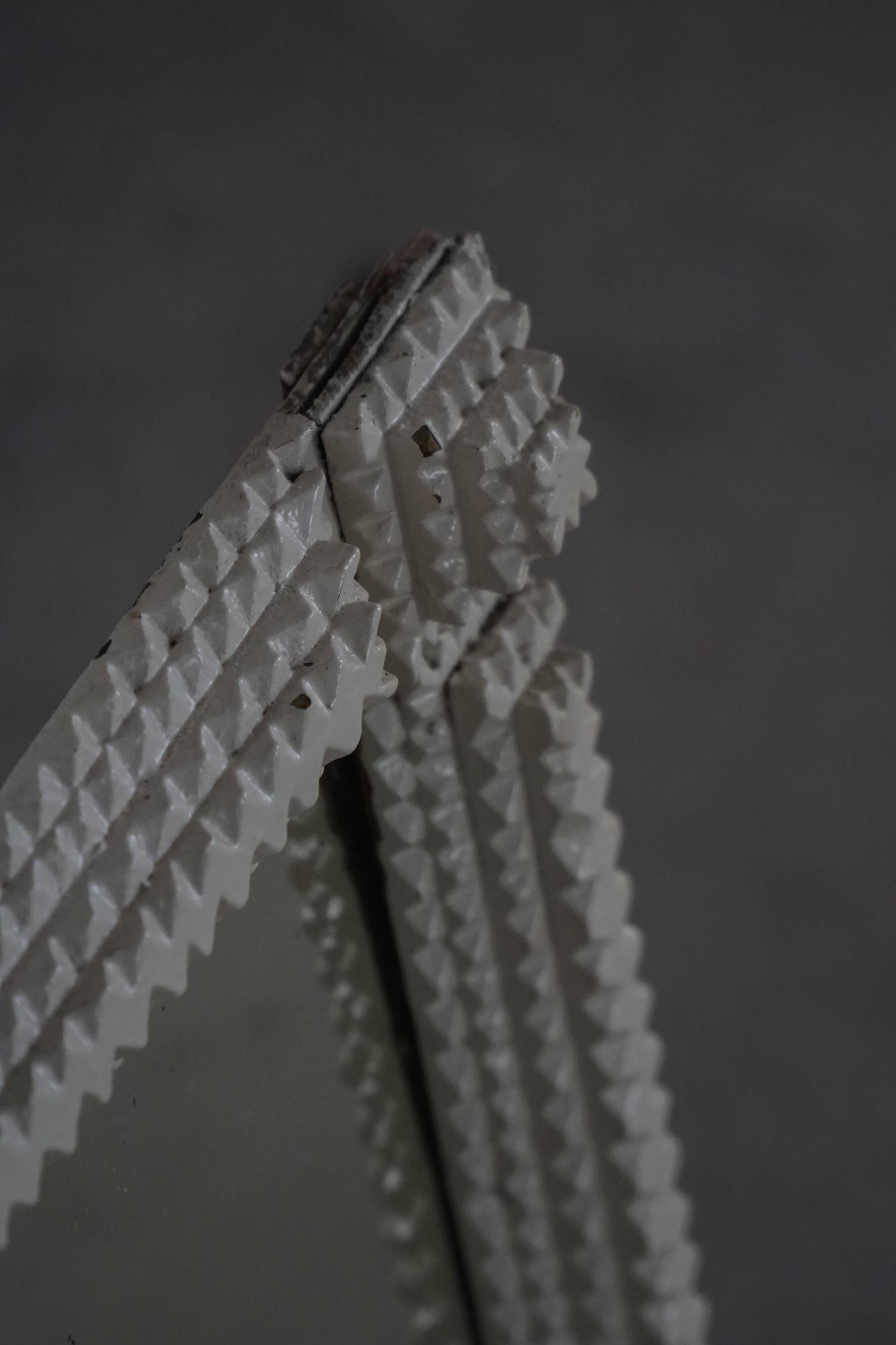 Wall mirror in tramp art style, hand-carved with a painted white frame, early 1900s.