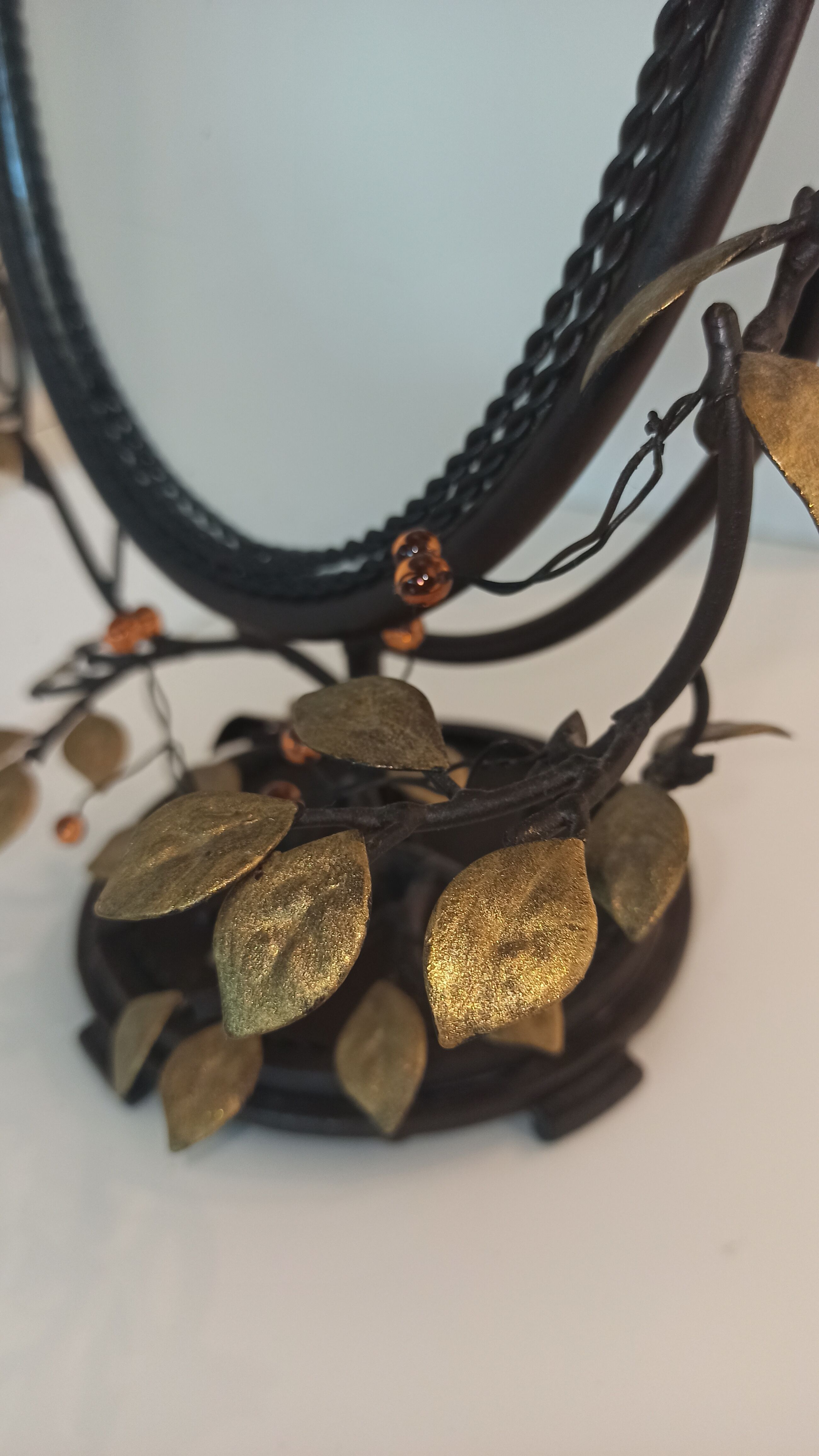 Table mirror, tilting psyche in patinated bronze decorated with leaves and fruits