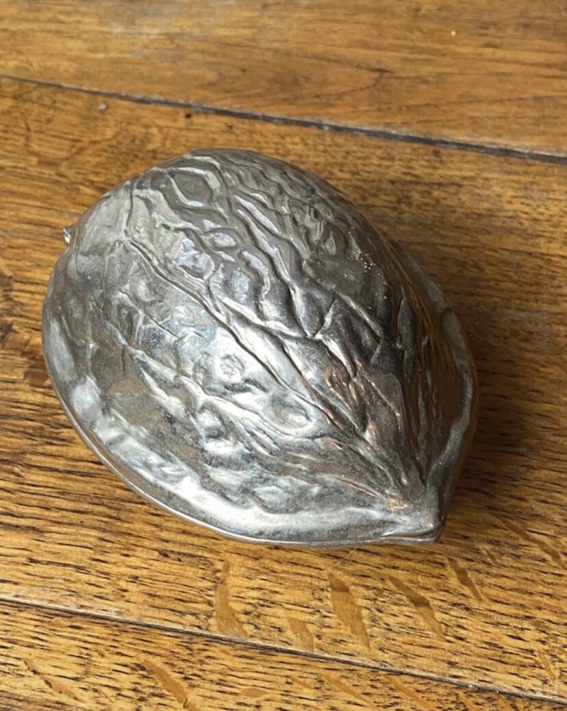 Nutcracker, shaped like a large nut, silver-plated metal