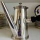 Christofle silver-plated chocolate pot and coffee pot with a blackened wooden handle.