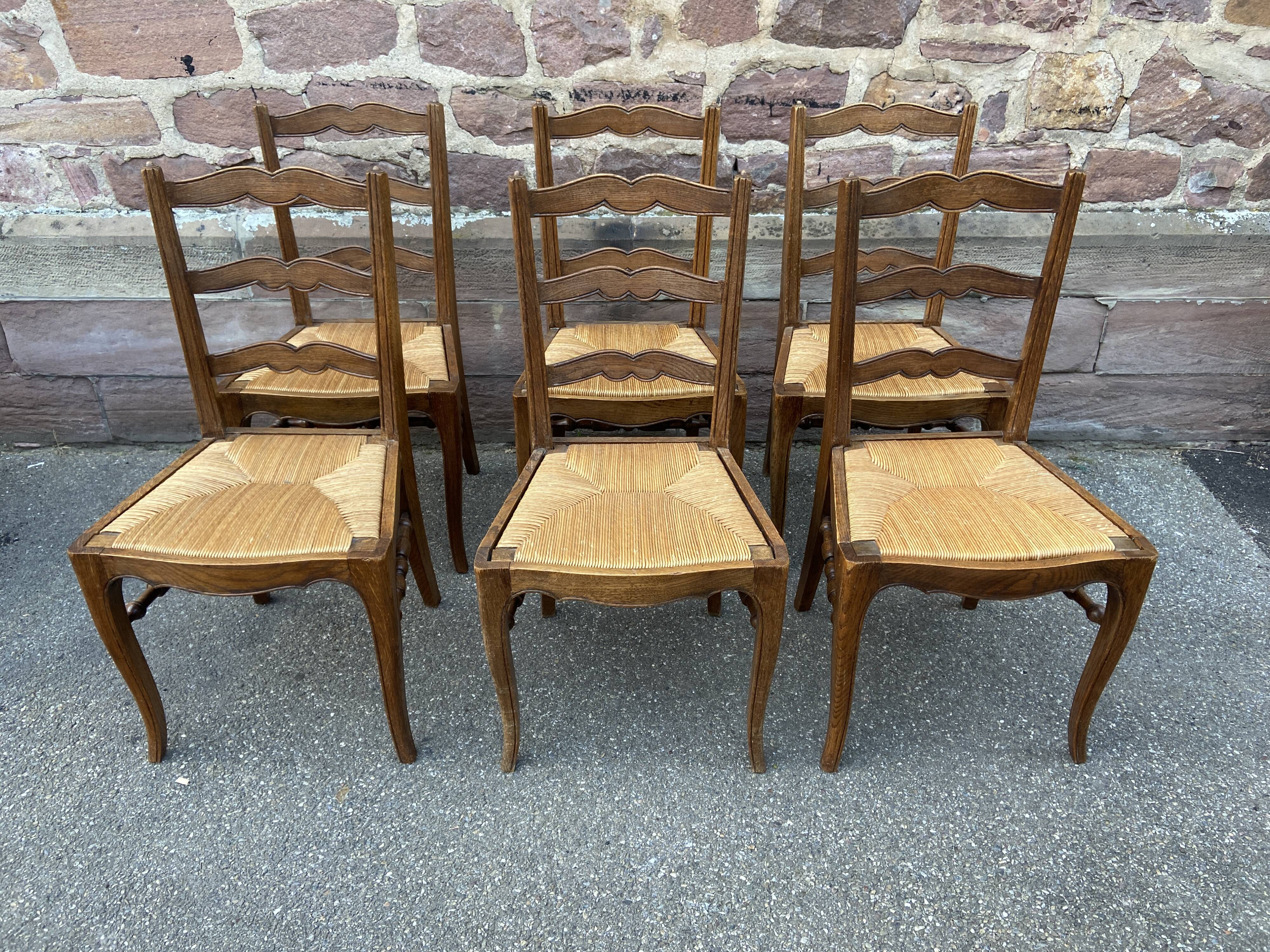 8 vintage rustic mulched chairs