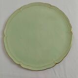 Large pastel green plate with a golden rim.