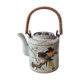 Japanese ceramic teapot. bird/paradise motifs/cherry trees. bamboo/rattan braided handle