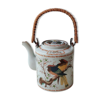 Japanese ceramic teapot. bird/paradise motifs/cherry trees. bamboo/rattan braided handle