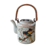 Japanese ceramic teapot. bird/paradise motifs/cherry trees. bamboo/rattan braided handle