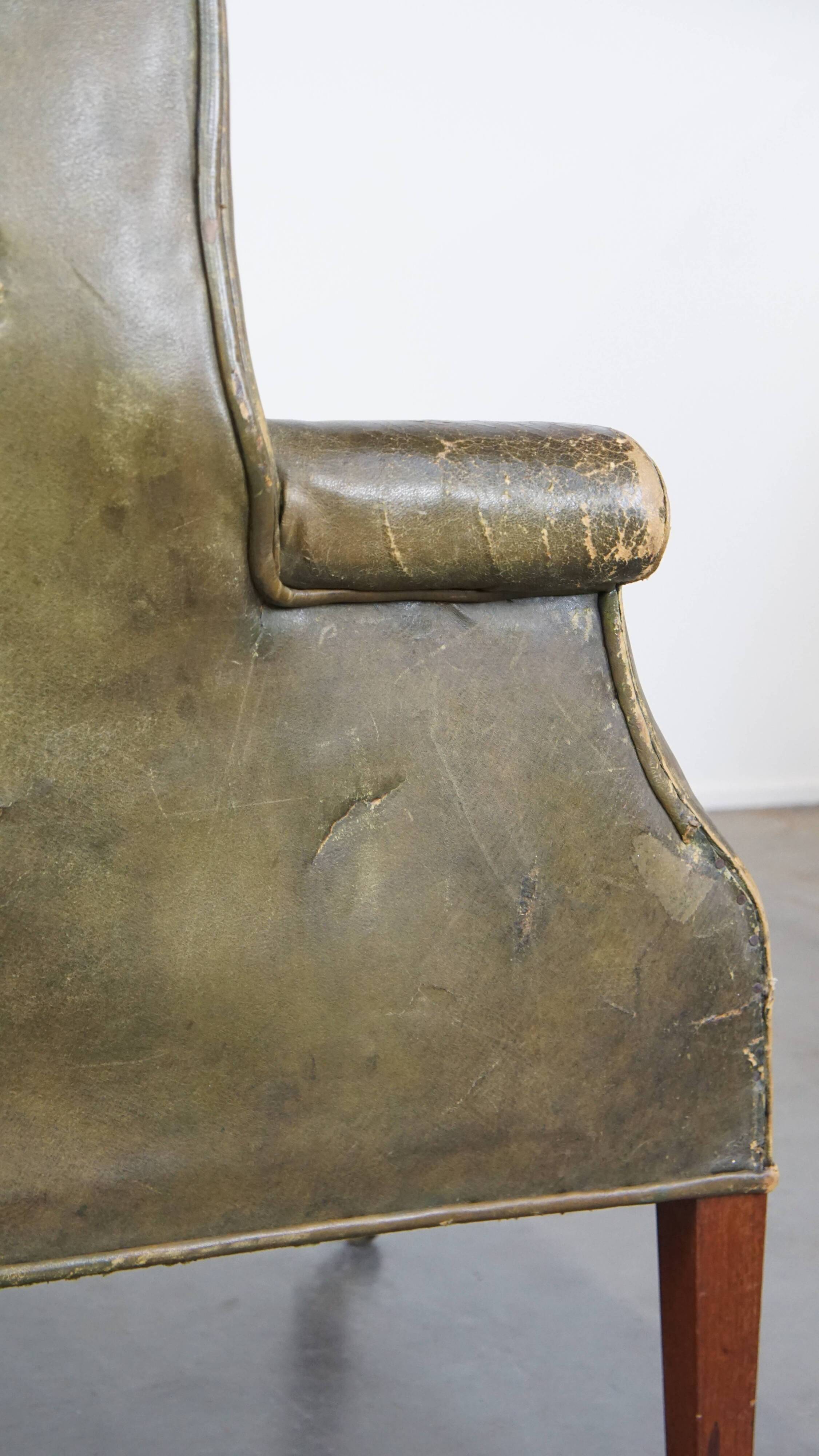 Green antique barrel back wingback chair on wheels
