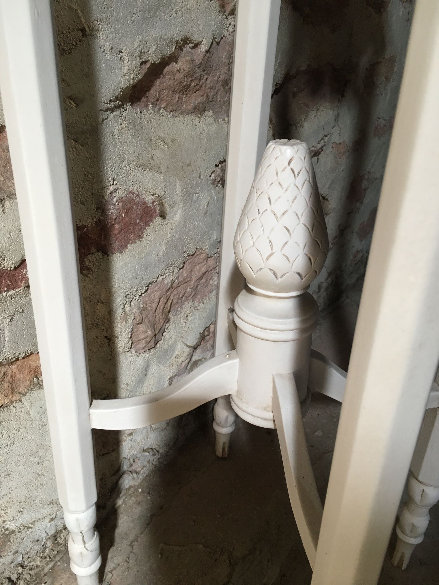 Carved wooden stool with a white patina.