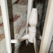 Carved wooden stool with a white patina.