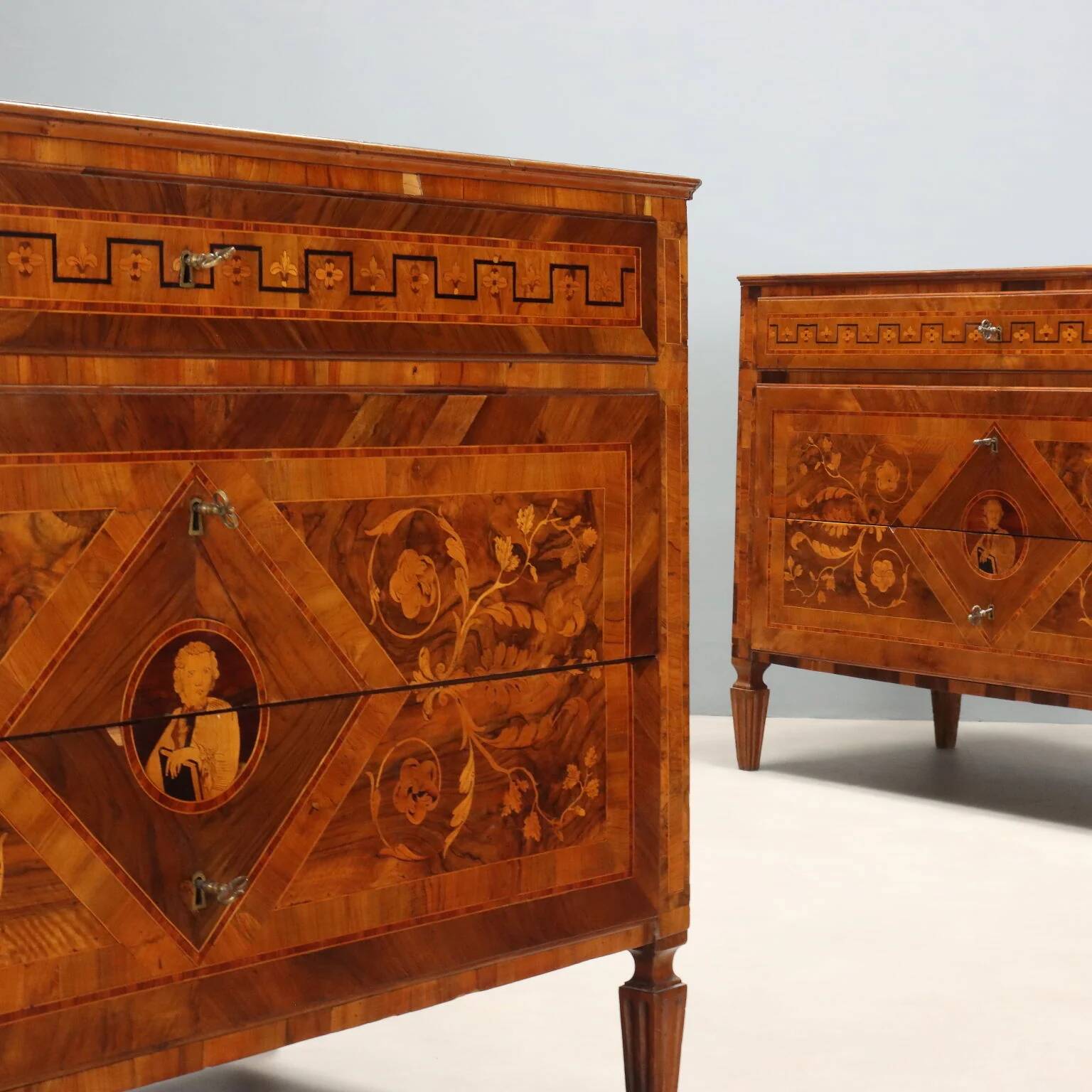 Pair of antique neoclassical walnut commodes from the 18th century.