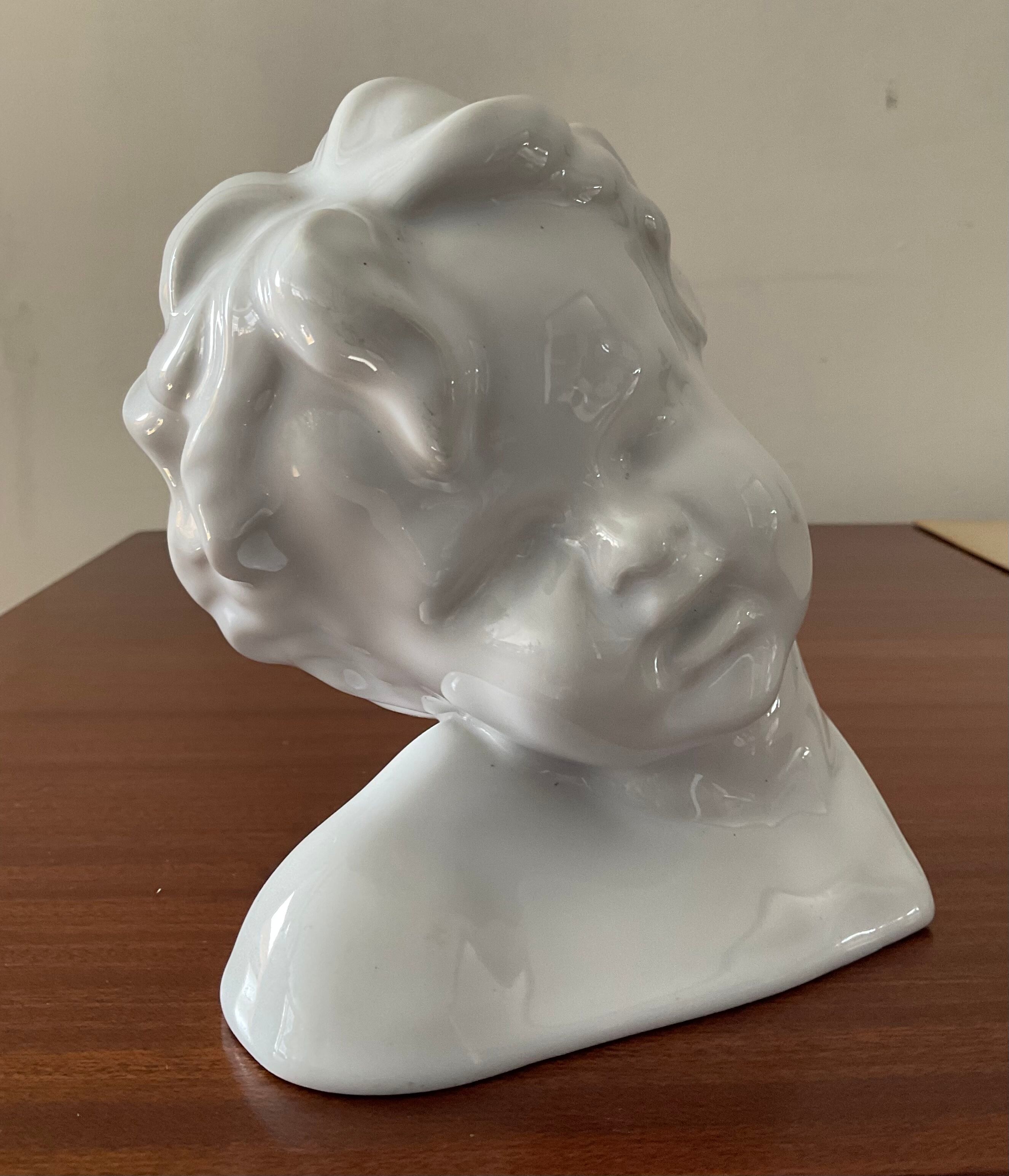 Cherub child bust in enamelled porcelain