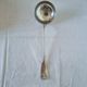 The Christofle silver-plated “Vendôme” cream ladle features a design