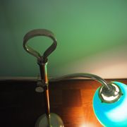 Desk lamp in brass with a swan neck and green opaline glass.
