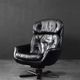 Vintage black leather swivel chair in mid-century modern Scandinavian style.