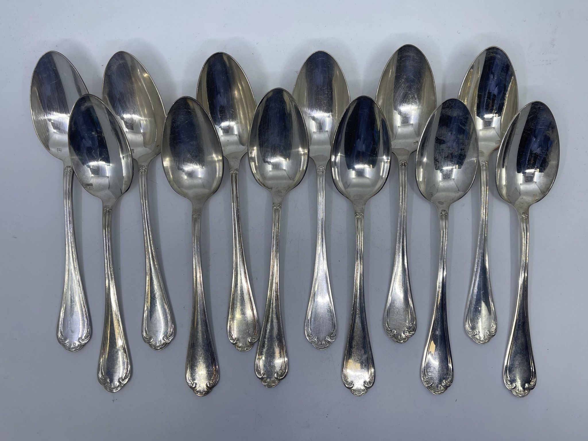 Set of 12 silver-plated soup spoons with Louis XV pattern.