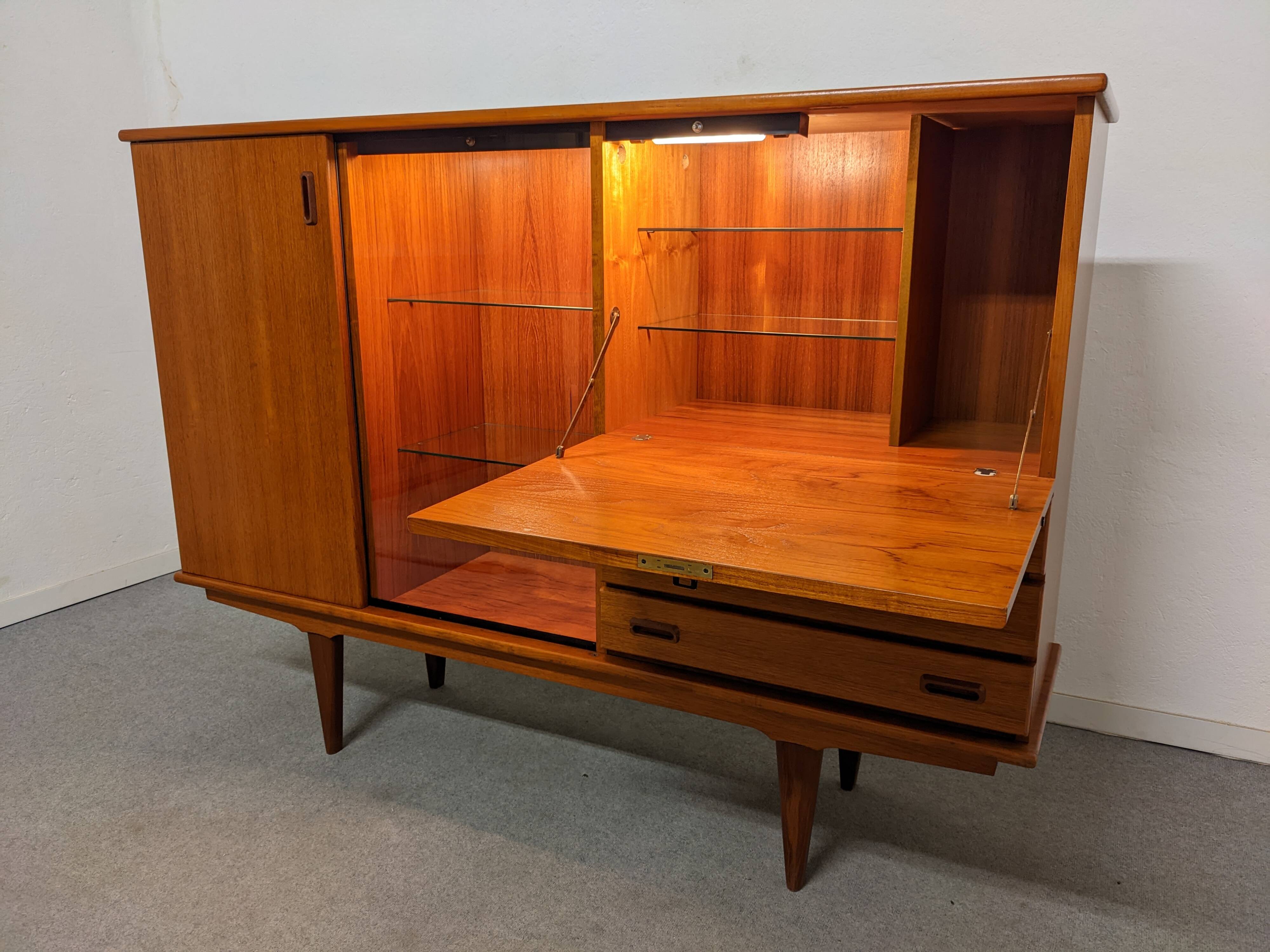 High sideboard, display cabinet and secretary, Scandinavian in teak, France around 1960.