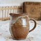 Small vintage hand turned ceramic milk jug with rustic glaze