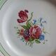 Old mismatched earthenware dinner plates with gold accompanied by a dish