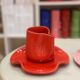 Set of ceramic artisan mugs with poppy red water lily design.