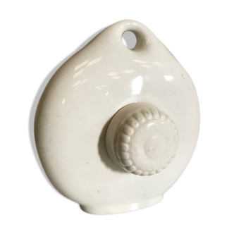 Old hot water bottle made of vintage white earthenware