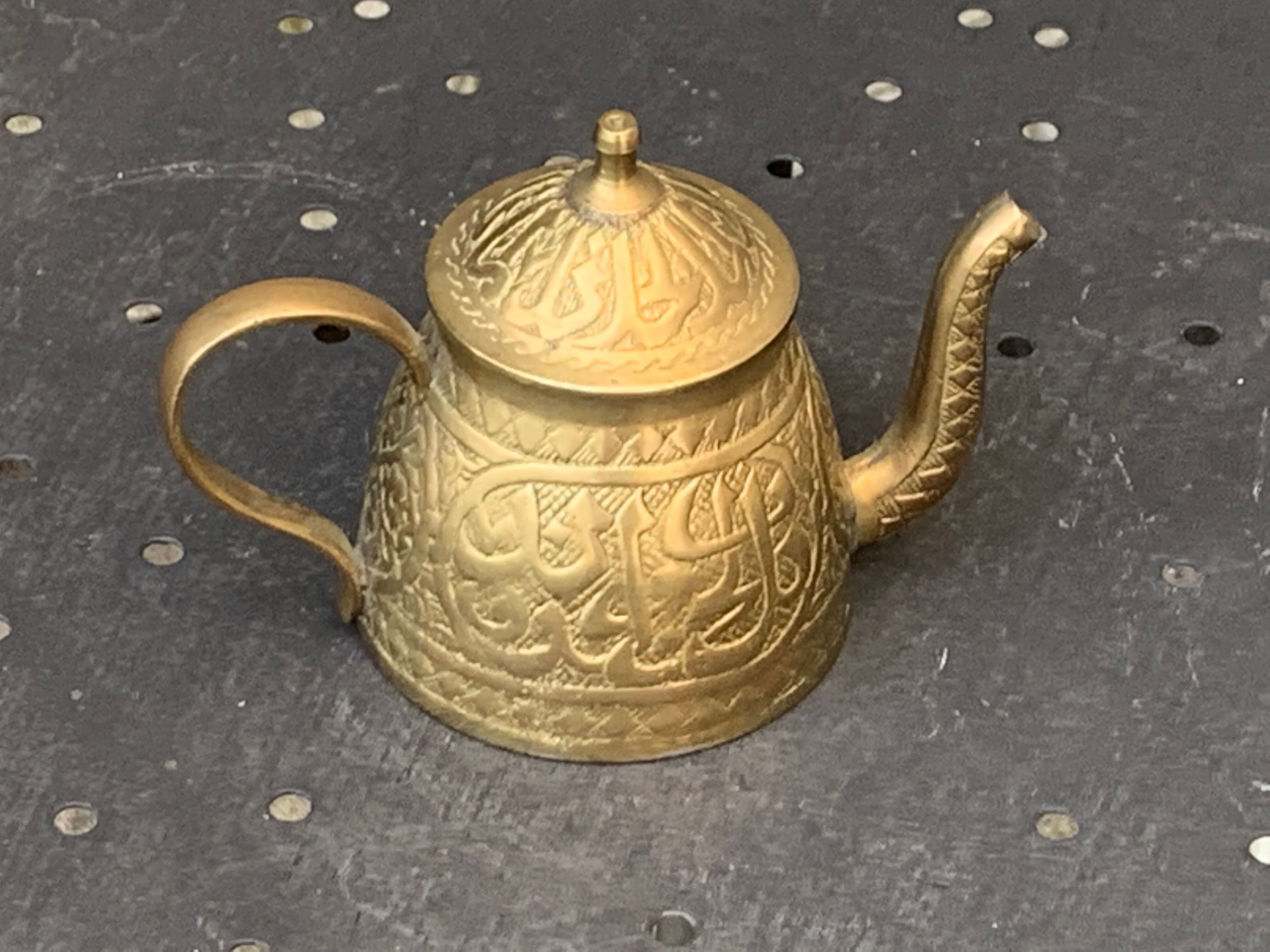 Small decorative teapot in vintage chiseled copper