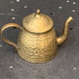 Small decorative teapot in vintage chiseled copper