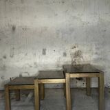 Trio of nesting tables, brass structures and smoked mirror tops