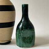 Ceramic vase with a glazed blue/green finish.